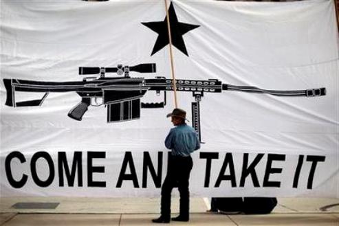 Austin Ehlinger helps hold a banner during a Guns Across America rally at the state capitol, Saturday, Jan. 19, 2013, in Austin, Texas. Texas officials opposed to new federal gun control proposals plan to speak on the steps of the state Capitol during a pro-Second Amendment rally. The event is one of many rallies planned across the country Saturday. They come four days after President Barack Obama unveiled a sweeping plan to curb gun violence. (AP Photo/Eric Gay)